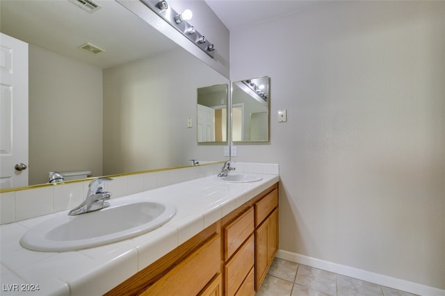 bathroom with vanity, toilet, and tile patterned flooring