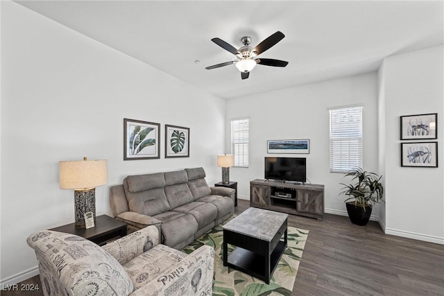 living room featuring ceiling fan and dark hardwood / wood-style floors