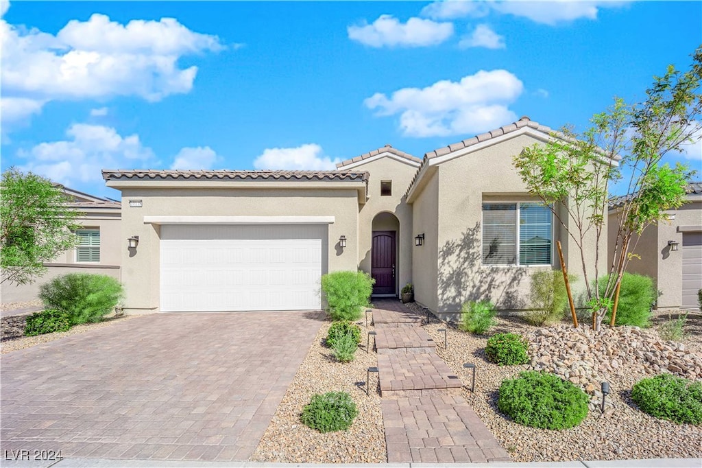 mediterranean / spanish-style house featuring a garage