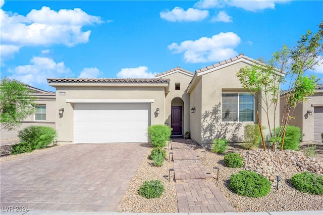 mediterranean / spanish-style house with a garage