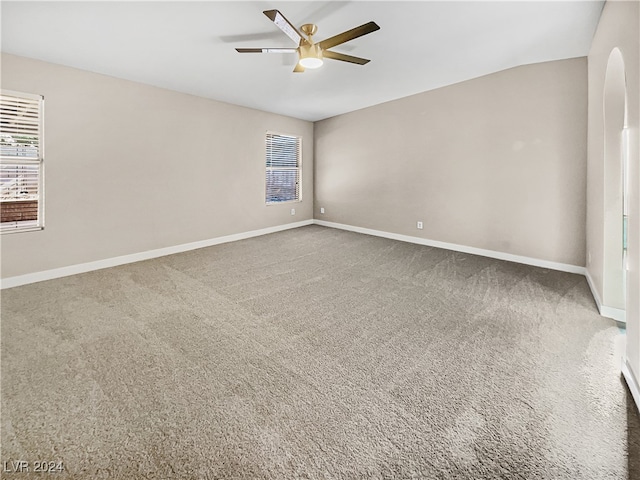 carpeted spare room featuring ceiling fan