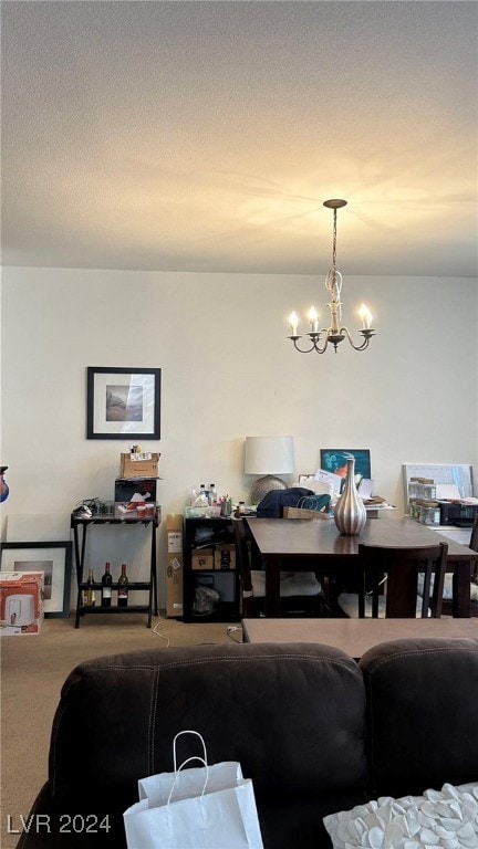 dining space featuring a chandelier and carpet