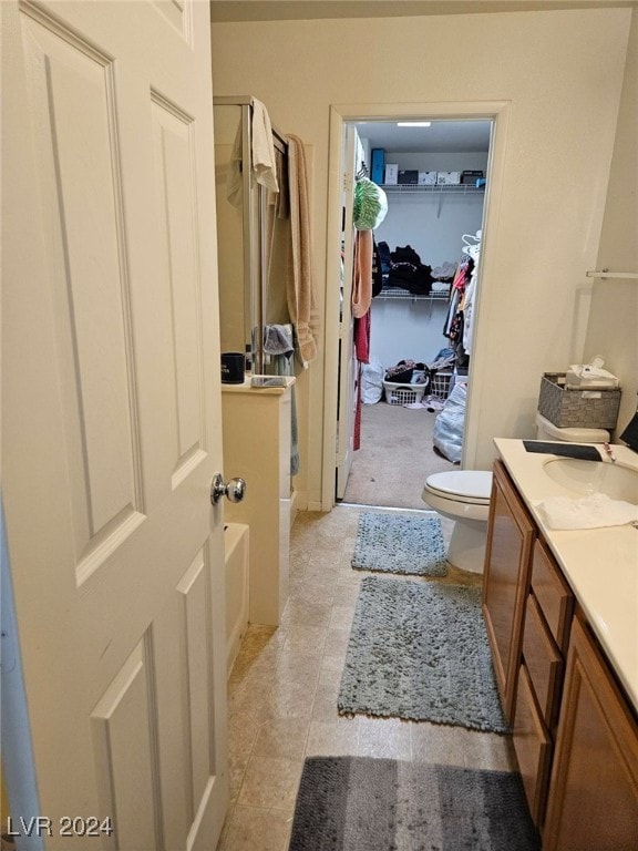 bathroom with vanity, toilet, and tile patterned flooring