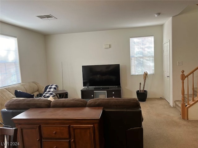 living room with a wealth of natural light and light colored carpet