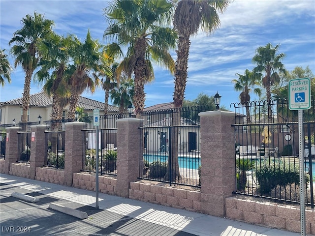 view of gate featuring a community pool