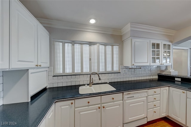 kitchen with dishwasher, sink, tasteful backsplash, white cabinets, and ornamental molding