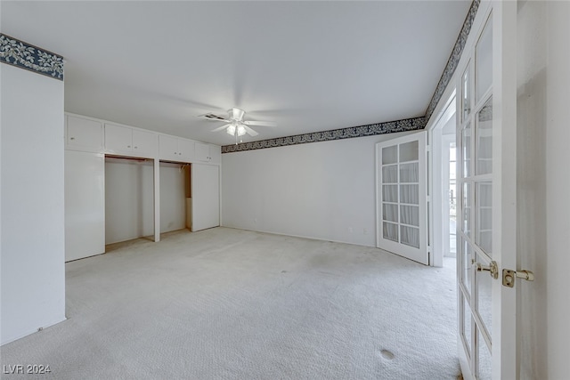 unfurnished bedroom featuring ceiling fan and light colored carpet