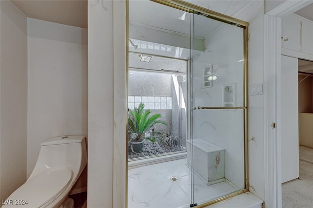 bathroom with toilet and a shower with shower door