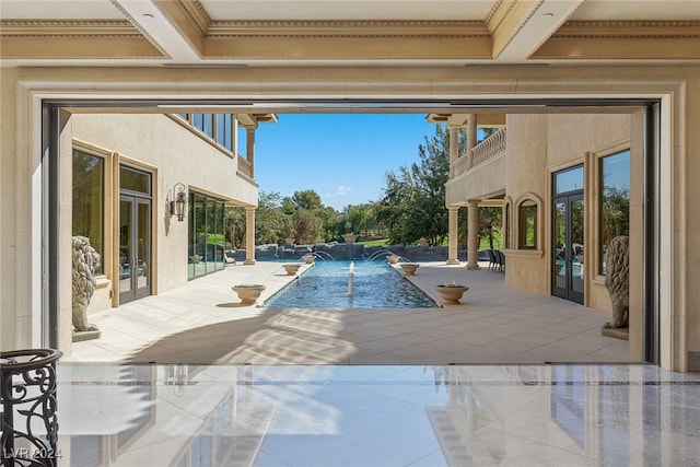 view of pool with pool water feature and a patio