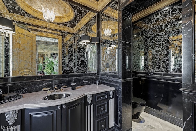 bathroom featuring tile walls, vanity, crown molding, and toilet