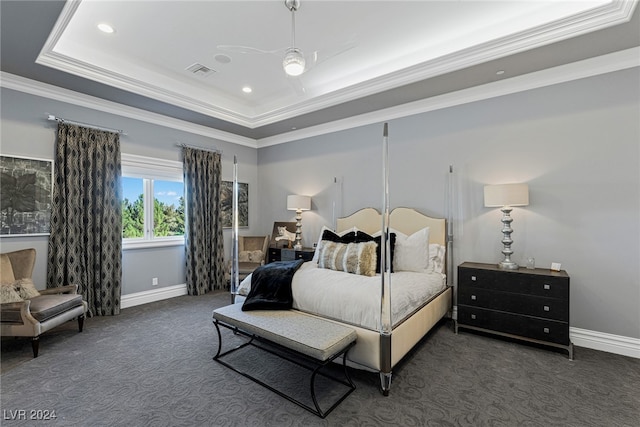 carpeted bedroom with ceiling fan, a raised ceiling, and crown molding