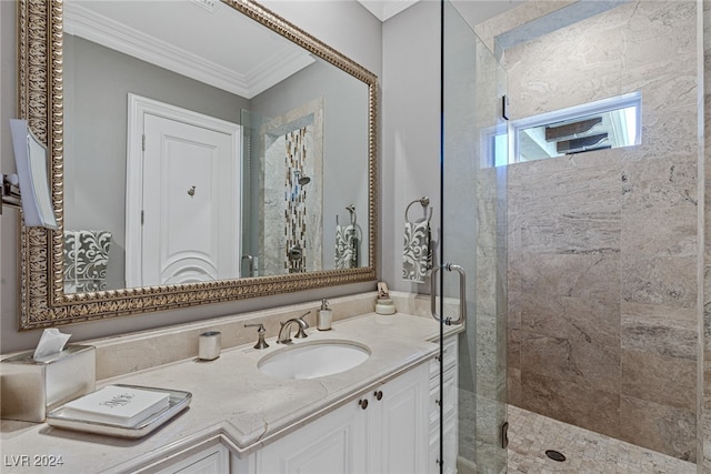 bathroom with a shower with door, crown molding, and vanity