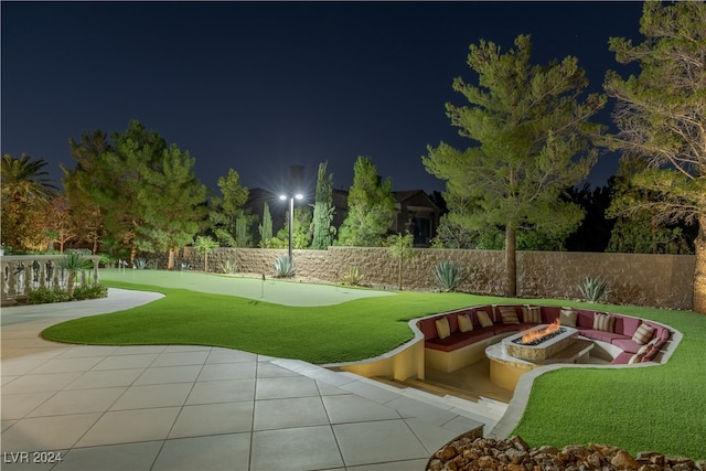 surrounding community featuring an outdoor fire pit and a patio area