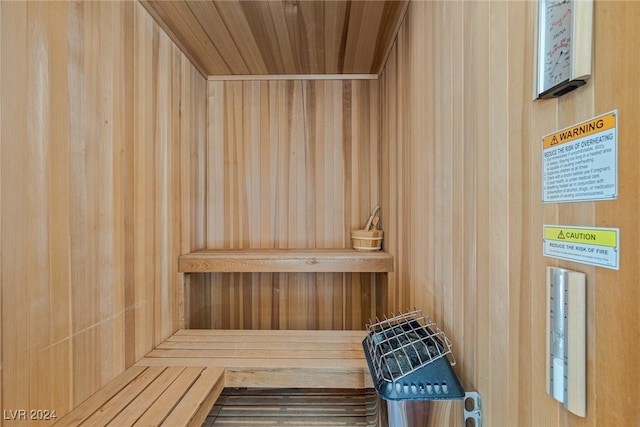 view of sauna / steam room featuring wood ceiling and wood walls