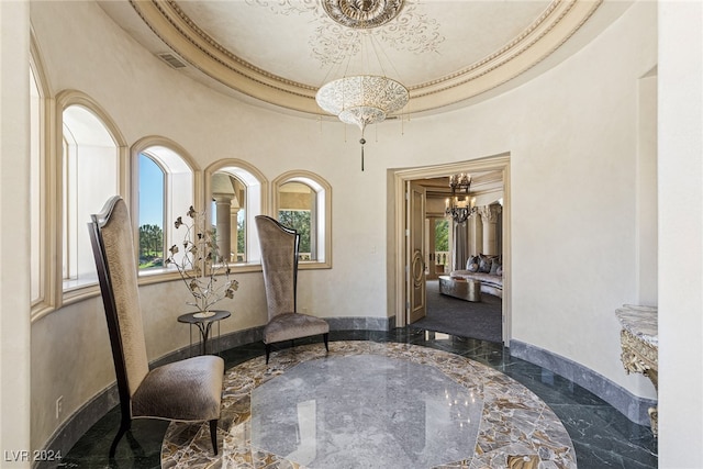 sitting room featuring crown molding, a raised ceiling, and a chandelier