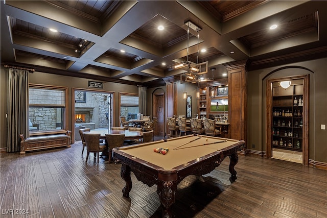 recreation room featuring beamed ceiling, dark wood-type flooring, a fireplace, and coffered ceiling