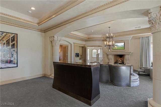 kitchen with a high end fireplace, decorative columns, dark colored carpet, and a tray ceiling