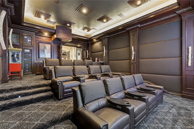 carpeted cinema featuring wood walls and ornamental molding