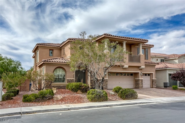 mediterranean / spanish-style home featuring a garage