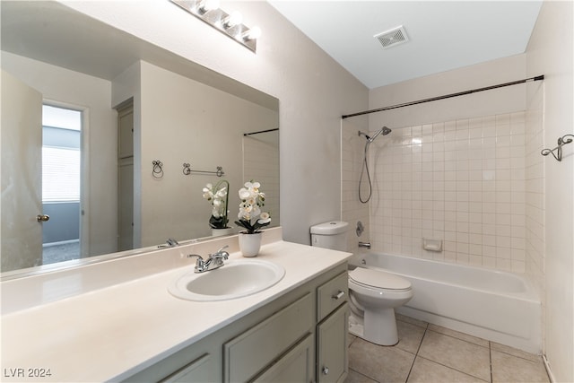 full bathroom featuring toilet, tile patterned flooring, vanity, and tiled shower / bath