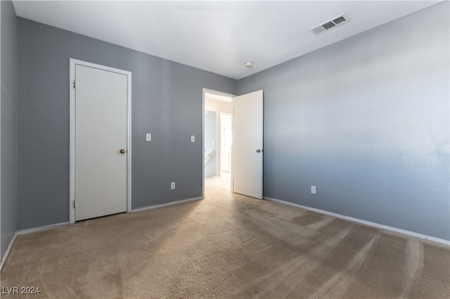 empty room featuring light colored carpet