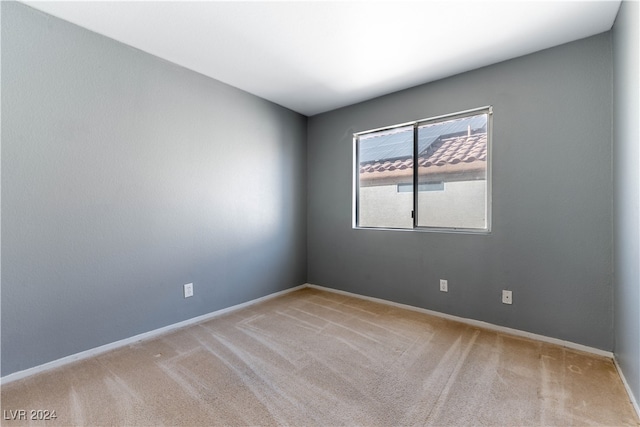 empty room featuring light carpet