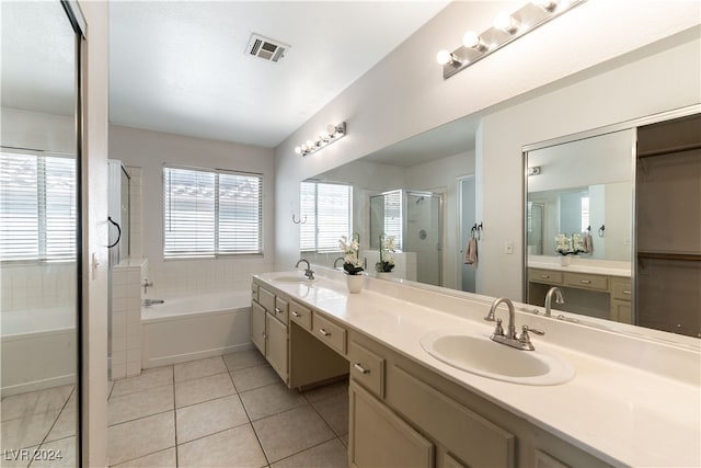 bathroom featuring plus walk in shower, vanity, and tile patterned flooring