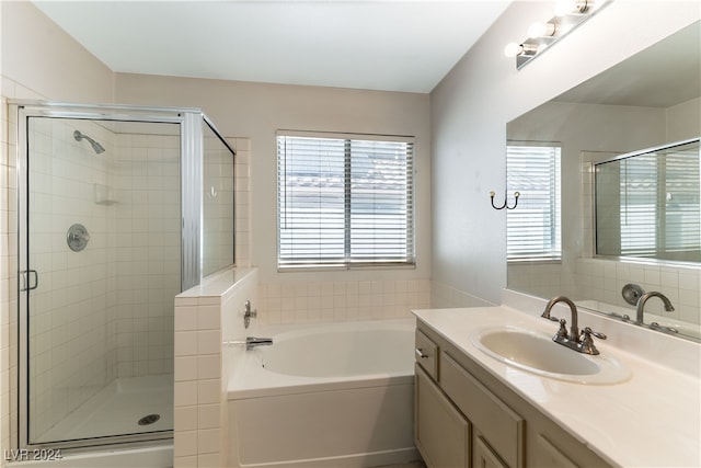 bathroom with vanity and separate shower and tub