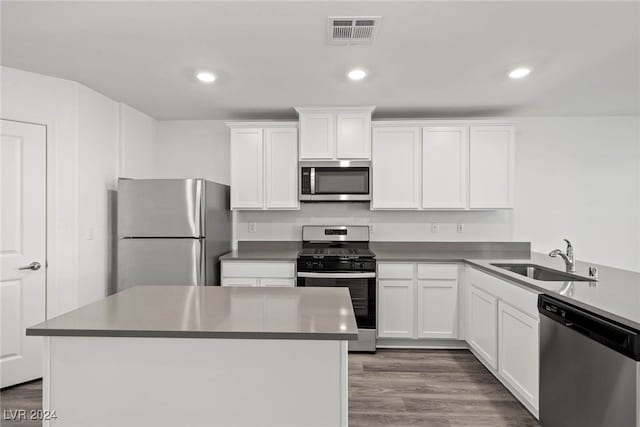 kitchen with white cabinetry, stainless steel appliances, dark wood-type flooring, and sink