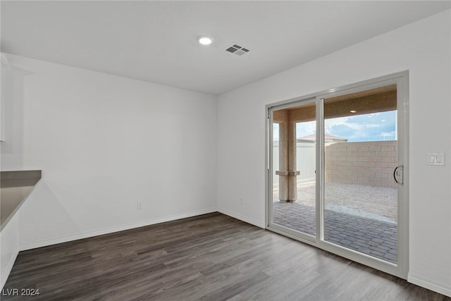 unfurnished room with dark hardwood / wood-style floors