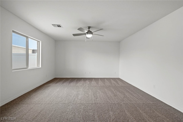 spare room with ceiling fan and carpet