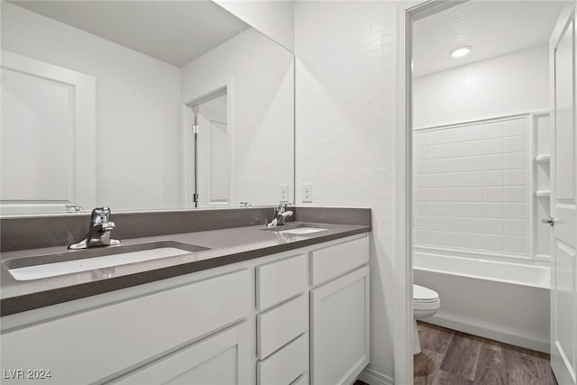 full bathroom featuring vanity, toilet, hardwood / wood-style flooring, and shower / bathing tub combination