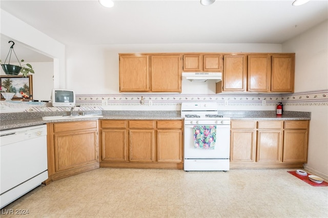 kitchen with sink, white appliances, and tasteful backsplash