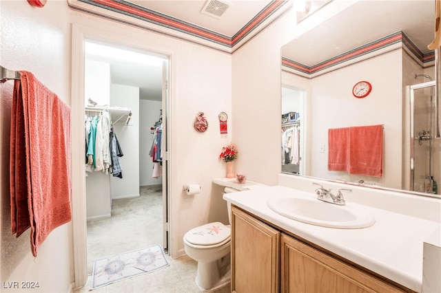 bathroom with vanity, toilet, tile patterned floors, and a shower with door