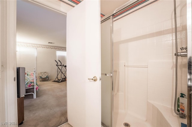 bathroom with a shower with door