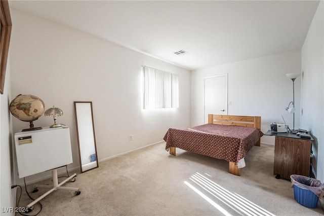 bedroom featuring light carpet