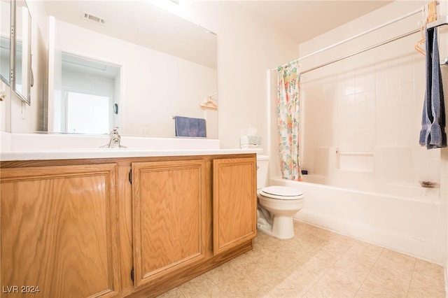 full bathroom with vanity, shower / tub combo, and toilet