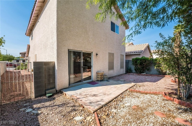 back of property featuring a patio