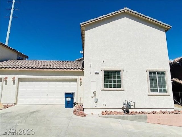 view of side of home featuring a garage