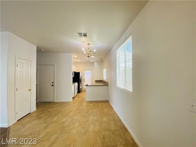 hallway with a notable chandelier