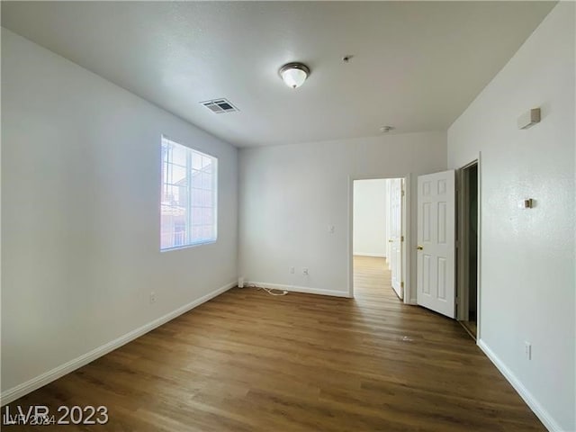 spare room featuring dark hardwood / wood-style floors