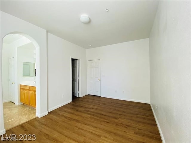 unfurnished room with dark wood-type flooring