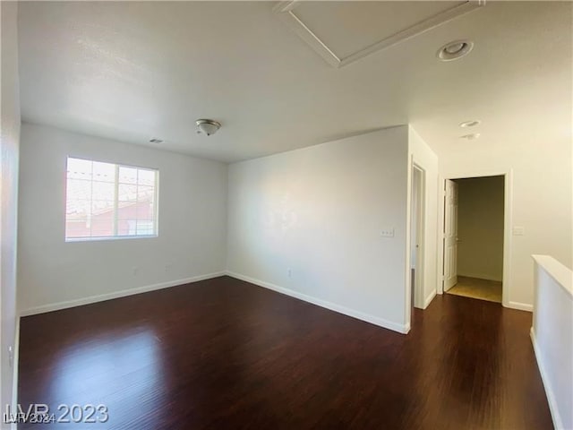 empty room with dark hardwood / wood-style floors