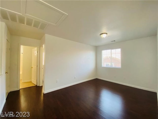 spare room with dark hardwood / wood-style flooring