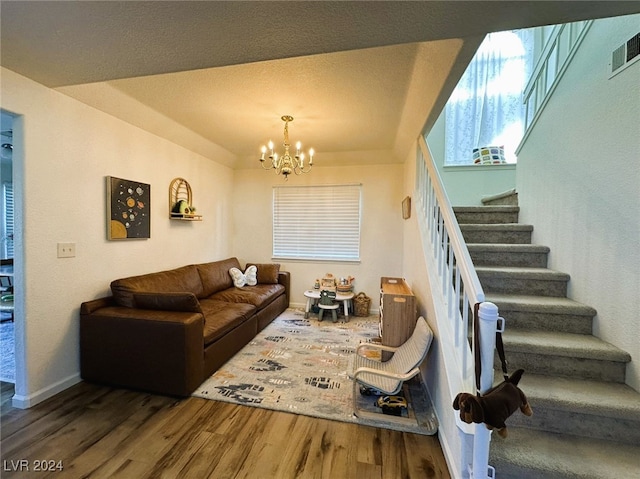 living room featuring hardwood / wood-style flooring and an inviting chandelier