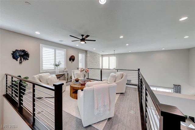 living room featuring light hardwood / wood-style floors and ceiling fan