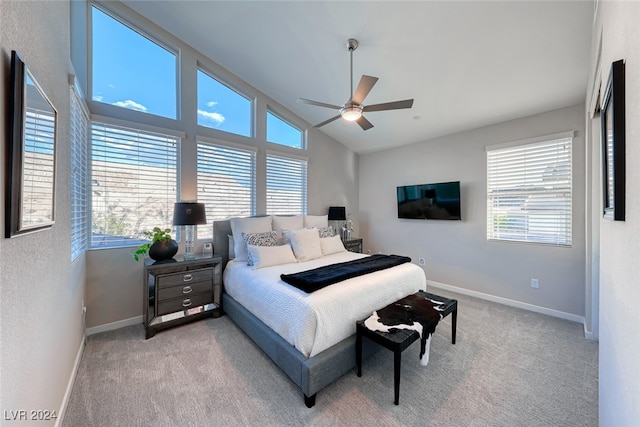 bedroom featuring ceiling fan, multiple windows, and light colored carpet