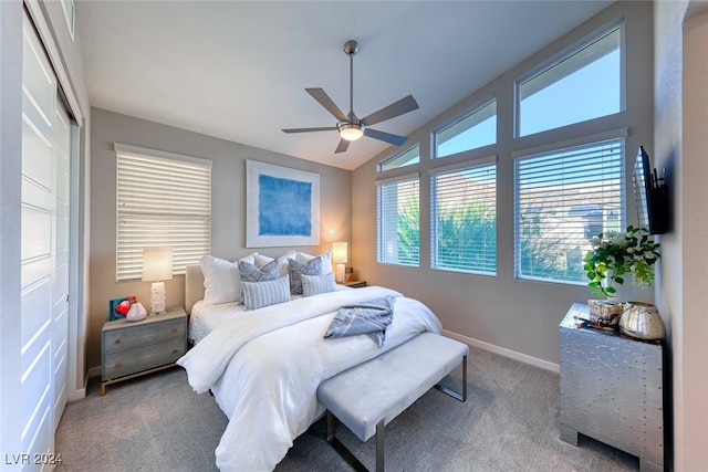 carpeted bedroom with a closet, ceiling fan, and vaulted ceiling