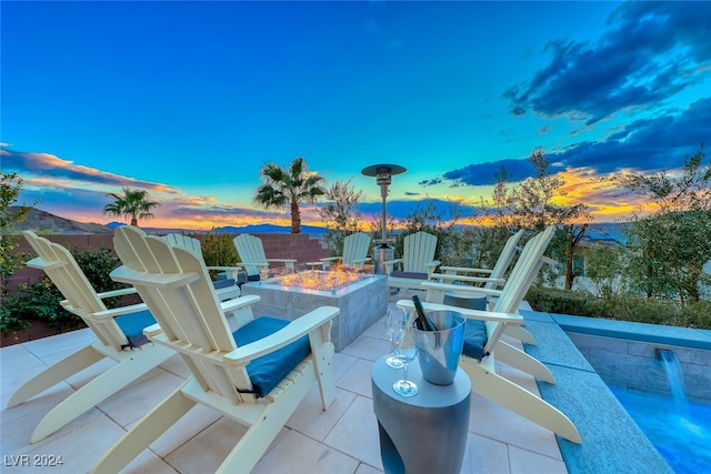 patio terrace at dusk featuring a fire pit