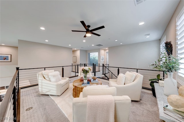 living room featuring light carpet and ceiling fan